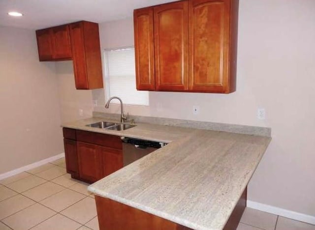 kitchen featuring kitchen peninsula, stainless steel dishwasher, light tile patterned floors, and sink