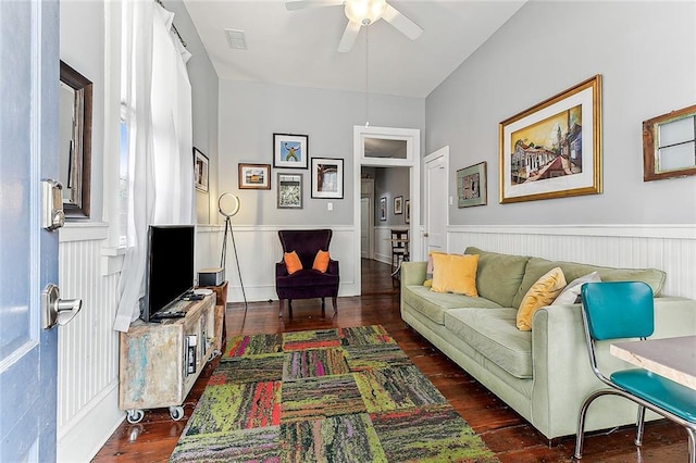 living room featuring wainscoting, ceiling fan, hardwood / wood-style floors, and visible vents