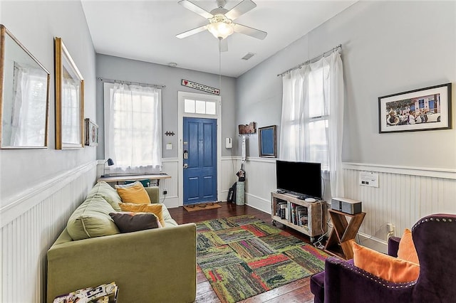 living room with dark wood-type flooring and ceiling fan