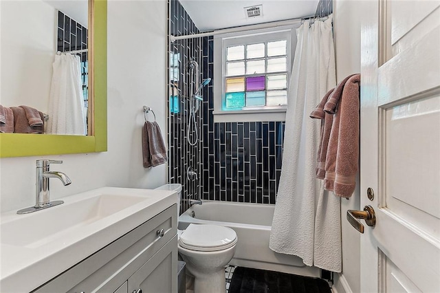 full bath featuring shower / bath combination with curtain, toilet, visible vents, and vanity