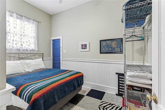 bedroom featuring wainscoting