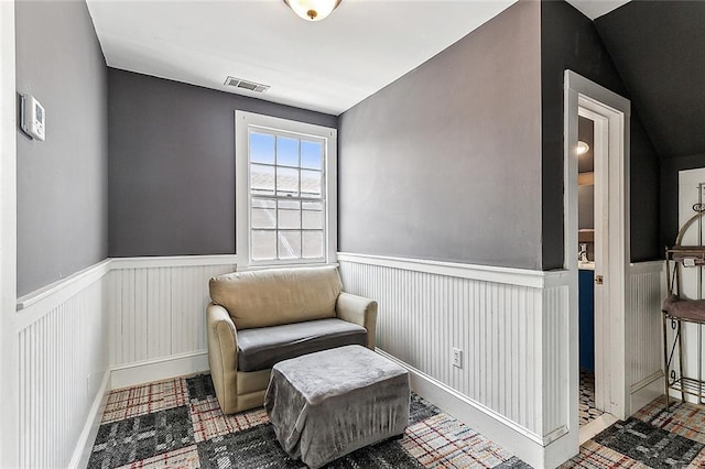 sitting room featuring visible vents and a wainscoted wall