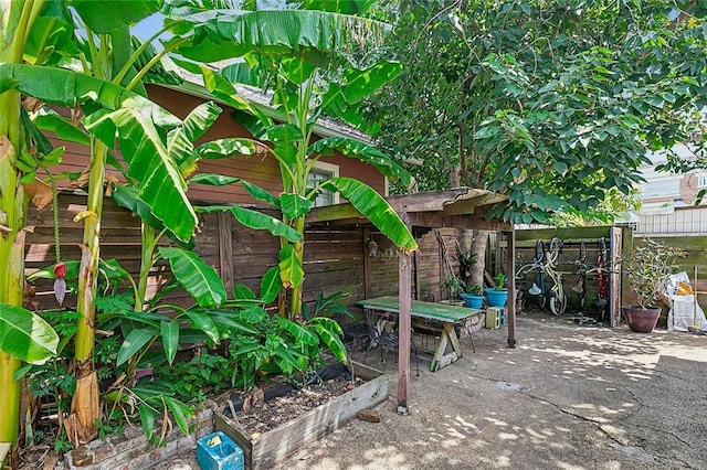 view of patio featuring a vegetable garden and fence