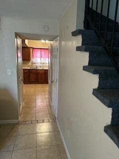 hall featuring light tile patterned flooring