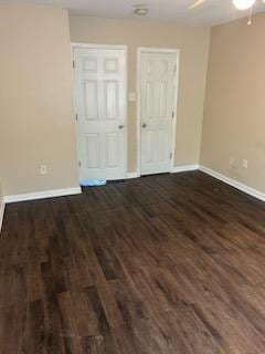 spare room with ceiling fan and dark wood-type flooring