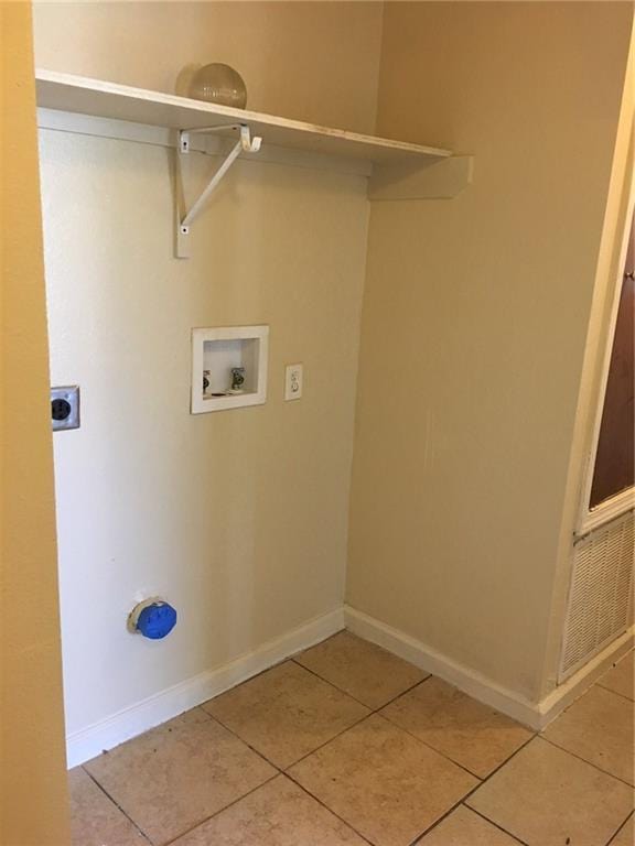 laundry area featuring hookup for a washing machine, light tile patterned floors, and electric dryer hookup