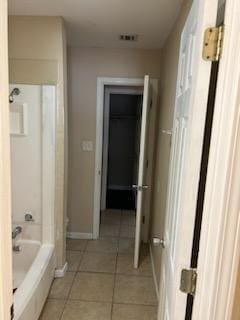 bathroom with tile patterned floors and shower / bathing tub combination