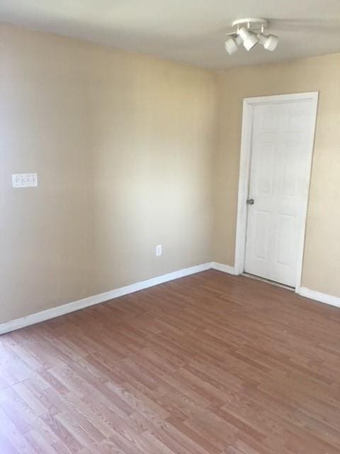 spare room with wood-type flooring