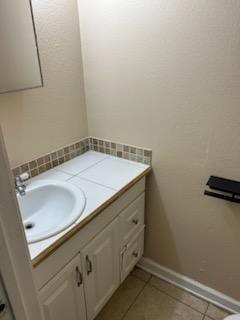 bathroom with tile patterned floors and vanity