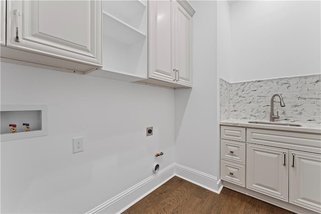 washroom with washer hookup, hookup for an electric dryer, dark hardwood / wood-style flooring, cabinets, and sink