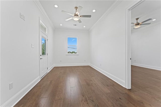 empty room with ornamental molding, ceiling fan, and dark hardwood / wood-style floors