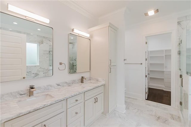 bathroom with crown molding, vanity, toilet, and a shower with door