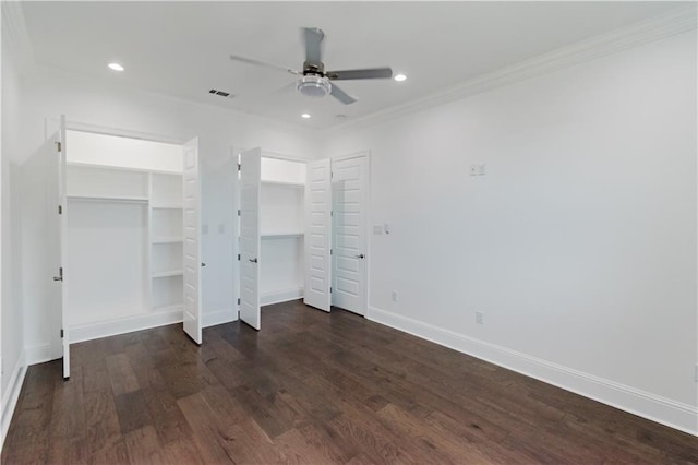 unfurnished bedroom with ceiling fan, dark wood-type flooring, and crown molding