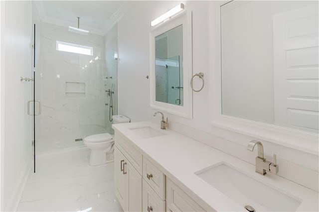 bathroom featuring vanity, crown molding, a shower with shower door, and toilet