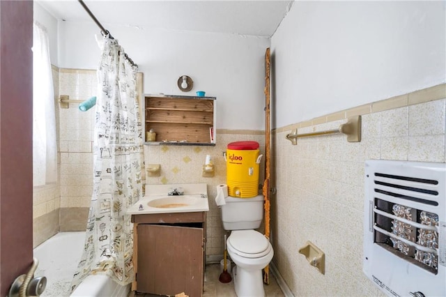 full bathroom with tile walls, vanity, shower / tub combo, and toilet