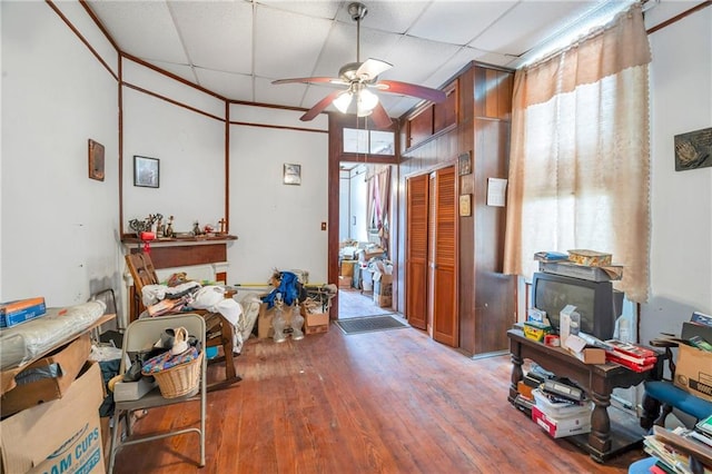 miscellaneous room with ceiling fan, a towering ceiling, and hardwood / wood-style floors