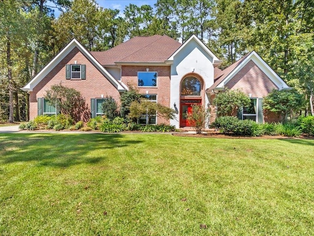 traditional-style home with brick siding and a front yard