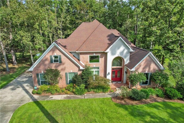 view of front of house featuring a front yard and french doors