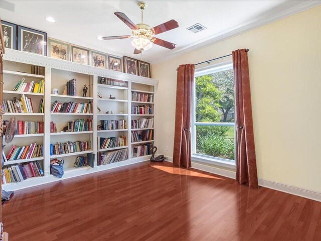 dining area with dark hardwood / wood-style flooring, crown molding, and a fireplace