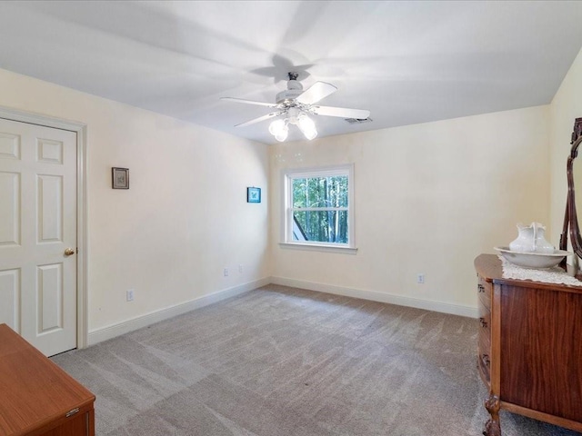 unfurnished bedroom featuring light carpet and ceiling fan