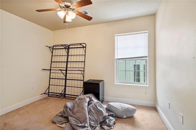 miscellaneous room with ceiling fan and light colored carpet