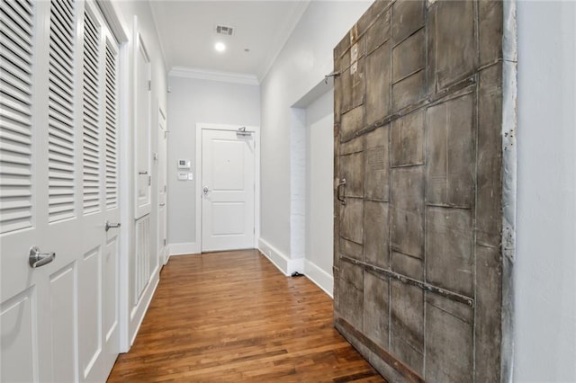 hall featuring wood-type flooring and crown molding