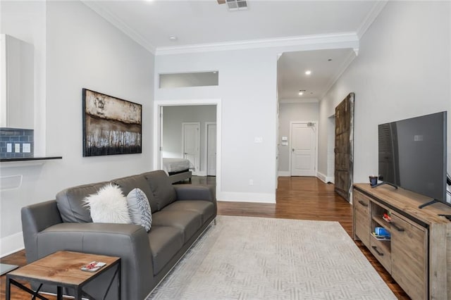 living room with ornamental molding and hardwood / wood-style floors