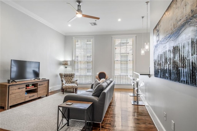 living room featuring crown molding, dark hardwood / wood-style floors, and ceiling fan