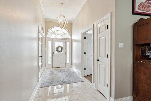 entrance foyer featuring ornamental molding and a chandelier