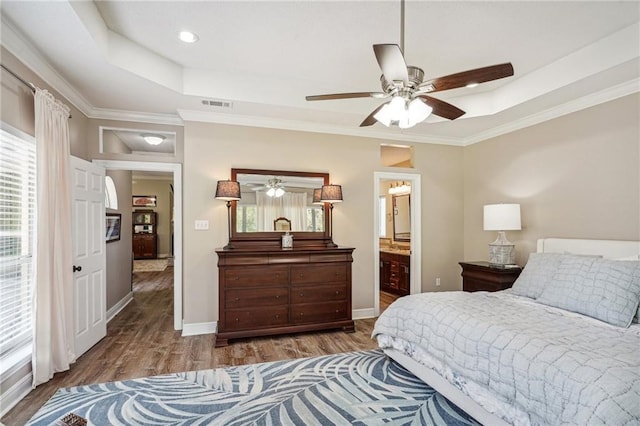 bedroom with ceiling fan, crown molding, hardwood / wood-style floors, and multiple windows