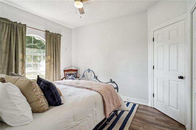 bedroom with ceiling fan and dark hardwood / wood-style floors