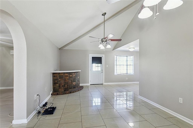 entryway featuring light tile patterned floors, ceiling fan, and high vaulted ceiling