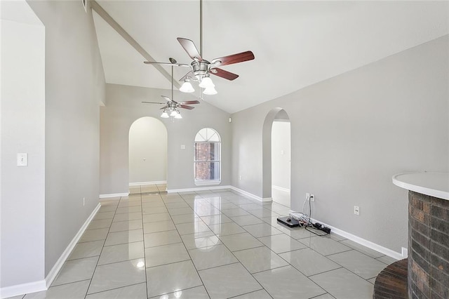 tiled empty room with lofted ceiling and ceiling fan