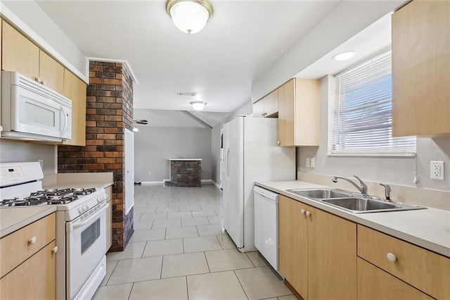 kitchen featuring light brown cabinets, sink, light tile patterned floors, and white appliances