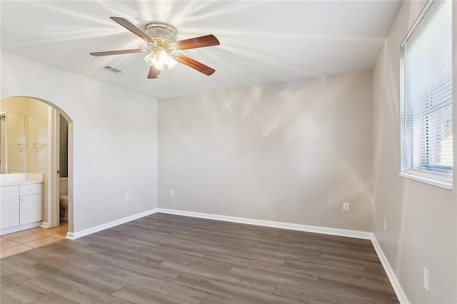 empty room featuring wood-type flooring and ceiling fan