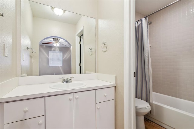 full bathroom with shower / bathtub combination with curtain, vanity, ceiling fan, toilet, and tile patterned floors