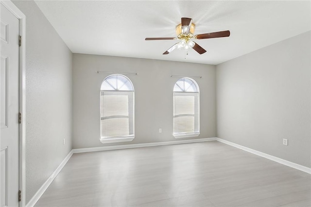 empty room with light hardwood / wood-style floors and ceiling fan