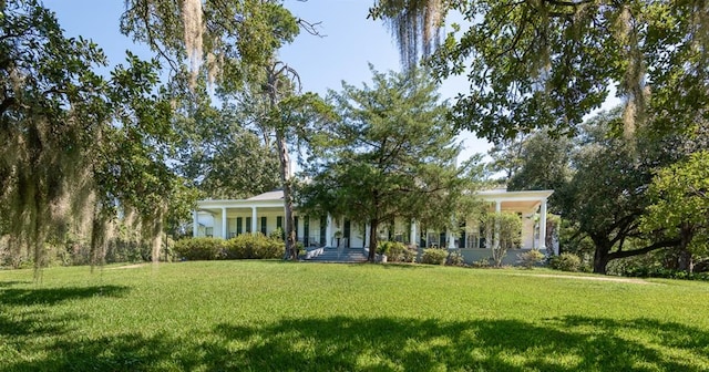 exterior space featuring covered porch and a yard