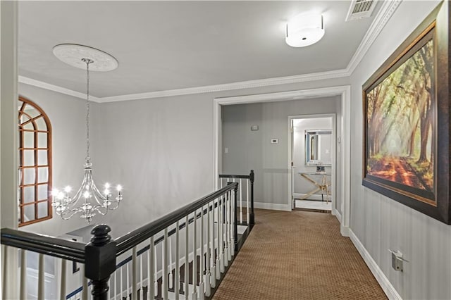 hall with carpet flooring, visible vents, crown molding, and an upstairs landing