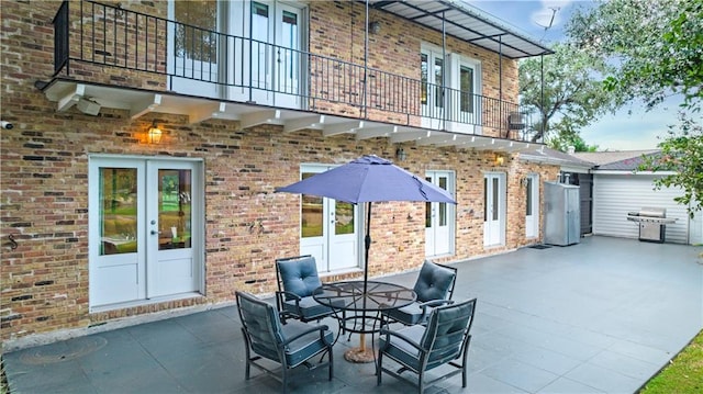 view of patio / terrace featuring french doors, a balcony, and area for grilling