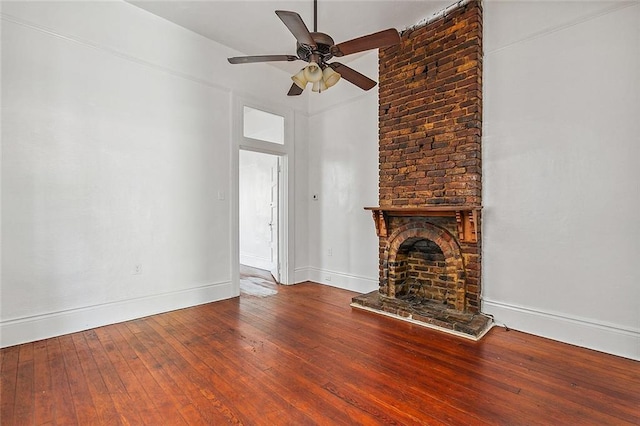 unfurnished living room with a brick fireplace, ceiling fan, and hardwood / wood-style flooring