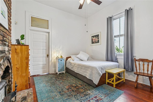 bedroom with dark hardwood / wood-style floors and ceiling fan