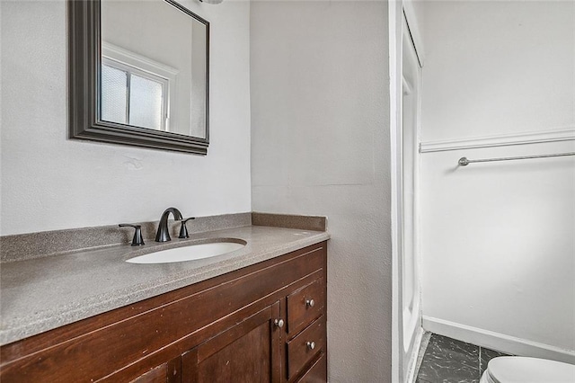 bathroom featuring walk in shower, vanity, and toilet