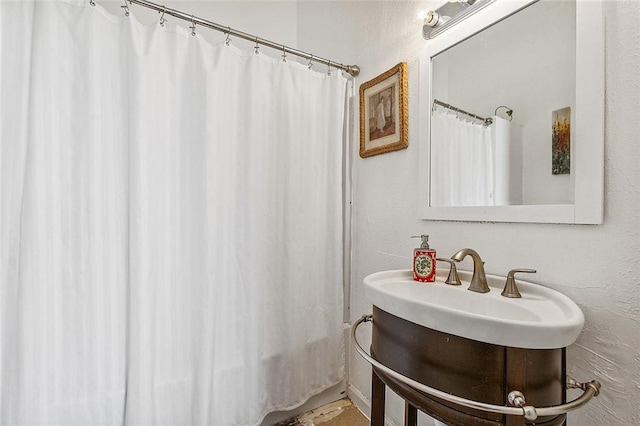 bathroom with walk in shower and vanity