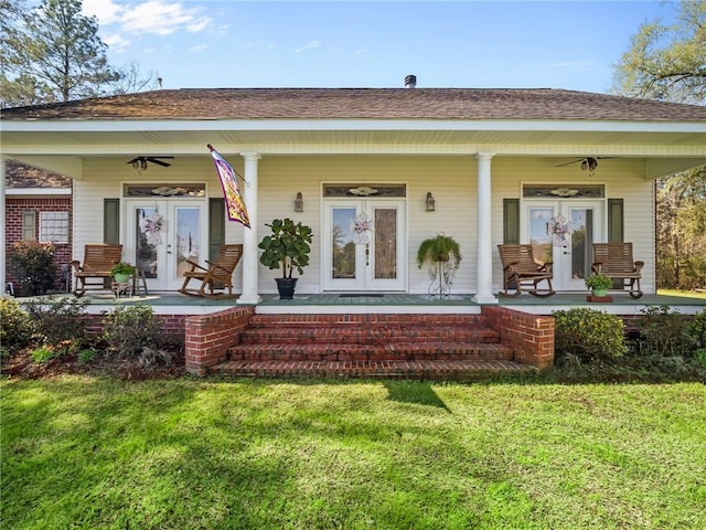 rear view of property featuring a lawn and a porch