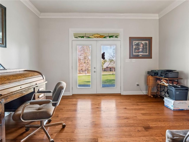 office space featuring light wood-type flooring, french doors, and crown molding