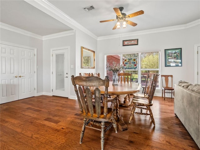 dining area with ceiling fan, crown molding, and dark hardwood / wood-style flooring