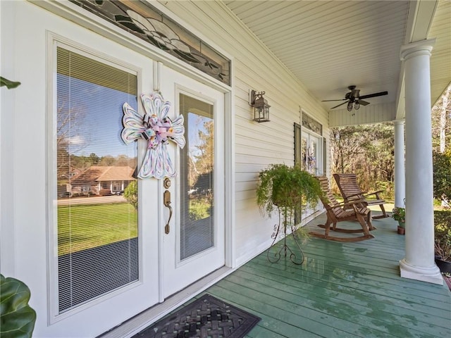 deck with ceiling fan and covered porch