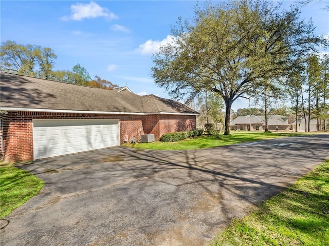 exterior space with cooling unit and a garage