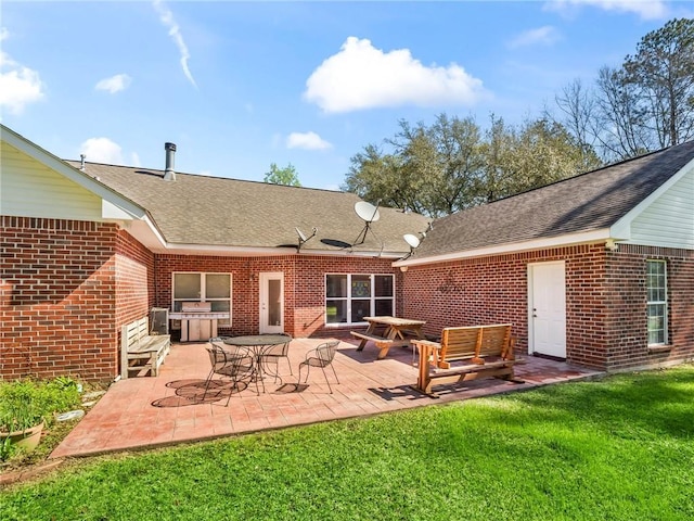 back of house featuring a patio area and a yard